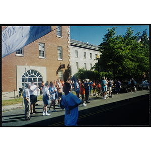 A boy runs past spectators at the Battle of Bunker Hill Road Race