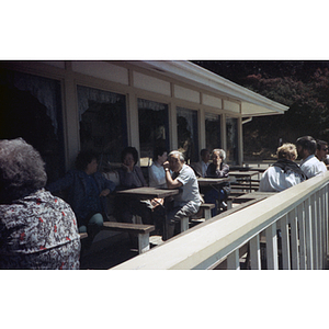Chinese Progressive Association members sit on a deck at an unidentified restaurant