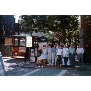 During a trip to Salem, Association members stand on a street corner and pose in a group, while a trolley stands gehind them