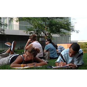 Nadia Alvarez and Odalis David Polanco lie in the grass during a scavenger hunt