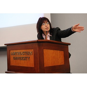 Ann Grenell gesturing during a speech