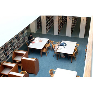 Students studying at tables in Snell Library