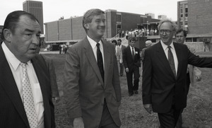 Ceremonial groundbreaking for the Conte Center: unidentified man, Gov. William Weld, and Provost Richard O'Brien walking to the site of groundbreaking
