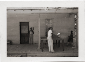 Unidentified children playing ping pong on porch of Rust Avenue house rented by the Congress of Federated Organizations (COFO)