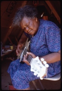 Older woman in tent playing an electric guitar, Resurrection City encampment