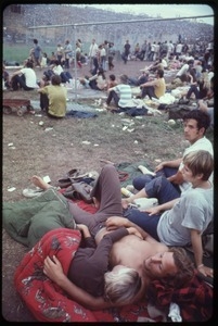 Couples lying on the grass and listening to music during the Woodstock Festival