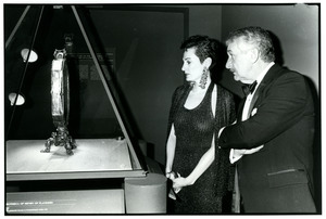 A couple examines a piece on exhibit