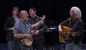 Suzanne Vega, Pete Seeger (banjo), Richard Barone, and Arlo Guthrie (guitar) performing at Symphony Space, New York City, in a concert to pay tribute to George Wein