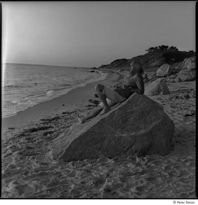 Ram Dass and Satsang: Ram Dass at the beach, reclining on a rock