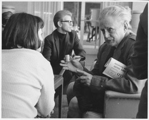 Hugh MacDiarmid, talking with a female student while others are in the background