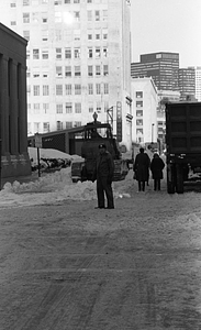 Pedestrians and snow clearing equipment on Stuart Street