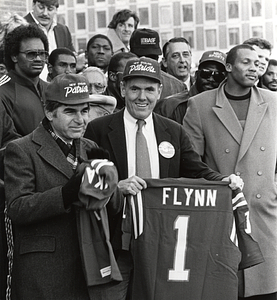 Mayor Raymond L. Flynn and Governor Michael Dukakis with New England Patriots players and others at celebration for New England Patriots 1985 team