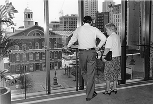 Mayor Raymond L. Flynn and an unidentified woman looking out the window of mayor's office