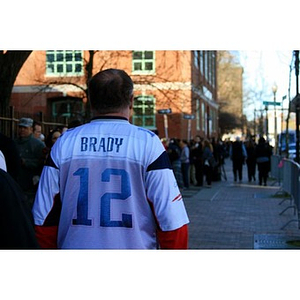 Man wearing Tom Brady New England Patriots jersey outside Boston Marathon interfaith memorial service at The Cathedral of The Holy Cross