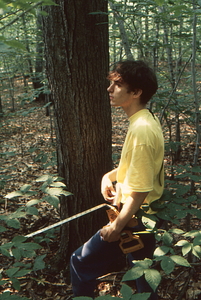 Jonah C. Wittkamper, Class of 1997, laying out measuring tape in Permanent Plot 1121 to measure sample tree height.