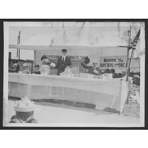 Boys stand at a Boston Young Men's Christian Association booth