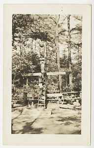 Man working on the Totem Pole in the council ring on East Campus
