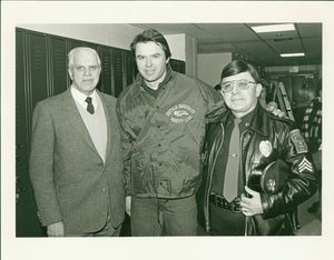Public Affairs Director Louis B. Connelly, Suffolk University Policeman Pat Piscatello meet actor Robert Urich during "Spencer for Hire" filming at Suffolk University