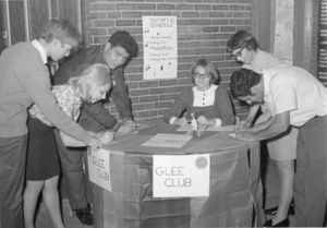 Sign up table for Suffolk University's Glee Club, circa 1965