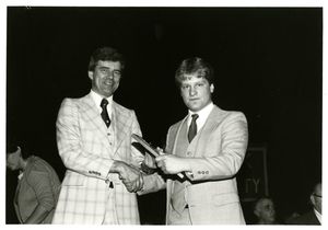 Athletics Director James E. Nelson with hockey player James Tropsa at Suffolk University's athletics dinner, 1980
