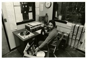 A deejay for Suffolk University's radio station (WFSR) in the studio, 1980