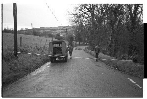 Murder scene, Dundrum, Co. Down, where local businessman and G.A.A. official John Kielty was murdered by Loyalists. His son Patrick is now a top television broadcaster and comedian. Various shots including some of the RUC carrying his remains in the re-usable tin coffin and placing it in the police wagon/hearse