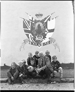 Sam McAughtry writer and journalist. With group of children at his birthplace in Belfast's Tiger's Bay area (Loyalist), standing in front of a UVF wall mural