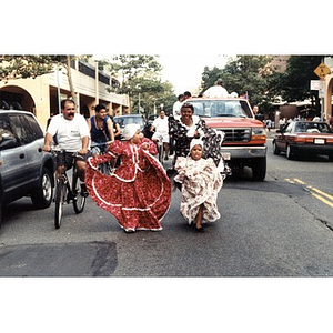 Woman and two children in traditional costume dance in the Festival Betances parade.