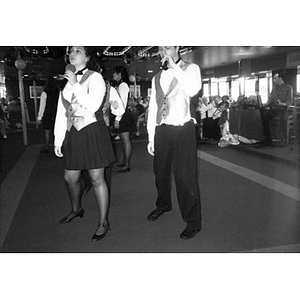 Singers entertaining the passengers on board a Boston Harbor Cruises boat, including Villa Victoria community members.