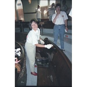 Volunteer varnishing a bench at the Jorge Hernandez Cultural Center.