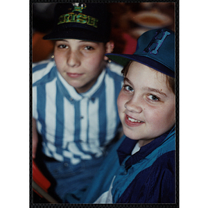 Two boys wearing hats pose for the camera at a Boys and Girls Club Awards Night