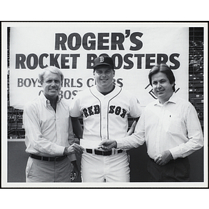 Boston Red Sox Roger Clemens, center, posing with two unidentified men holding a donation check at "Roger's Rocket Boosters" event