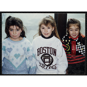 Three girls posing together, one of them wears a "DRUG FREE AND PROUD TO BE" ribbon, at a joint Charlestown Boys and Girls Club and Charlestown Against Drugs (CHAD) event