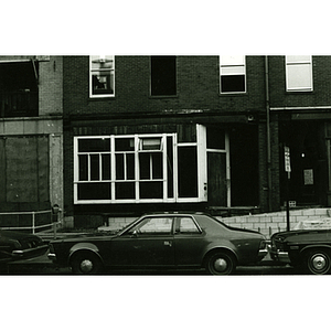 Exterior of brick buildings and cars parked along the street in Boston's Chinatown