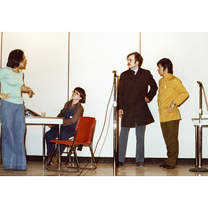 Two men and two woman perform a theatrical sketch onstage at the Josiah Quincy School about the normalization of U.S. and China relations