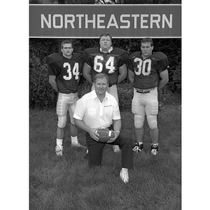 Three Northeastern football players and their coach