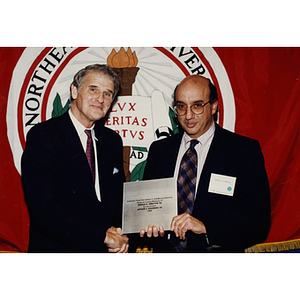 President Curry presents a plaque to Arthur Goldberg to commemorate Goldberg's donation of artwork