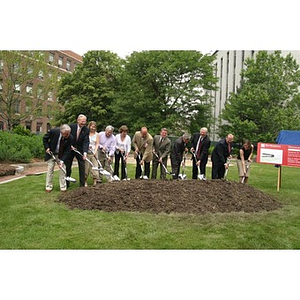 Several people with shovels break ground at the Veterans Memorial