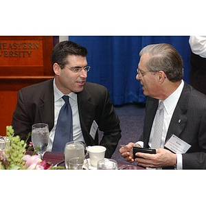 Eugene Reppucci and another man converse at The National Council Dinner