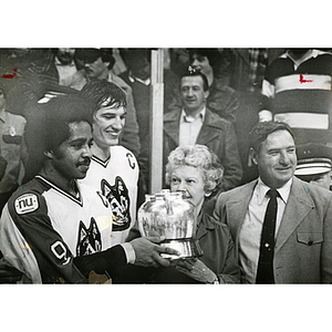 Captains Wayne Turner and Dave Archambault accept the Beanpot trophy