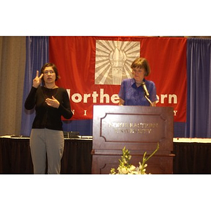 Gail Olyha and an American Sign Language interpreter at the Student Activities Banquet