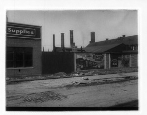 View of billboards and in-street tracks, probably on Dorchester Ave