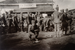 Soldiers lining up for food in front of an American Red Cross canteen
