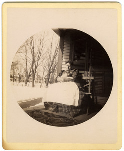 Mary Brown seated on porch with cat