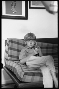 Teenage long hair: young boy watching the dance party from a couch, Coca Cola in hand