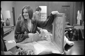 Judy Collins unwrapping a painting