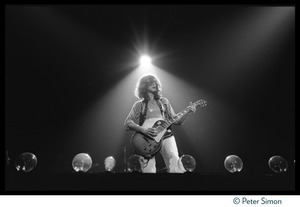 Jimmy Page (guitar) backlit with a spotlight on stage with Led Zeppelin during their Physical Graffiti tour