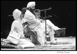 Yogi Bhajan (at microphone) on stage on the last night of the Kohoutek Celebration of Consciousness