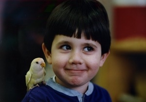 Michael Patalano, 4, shows off a lovebird perched on his shoulder