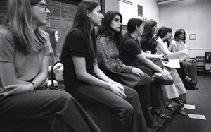 Women's liberation lecture at Boston University: women on foot of stage, Sue Katz speaking